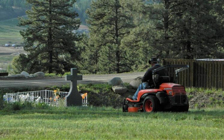 Staff mowing the cemetery