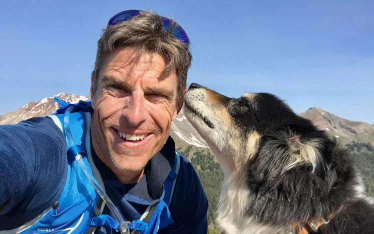 Mat deGraaf with his dog, who is licking his cheek